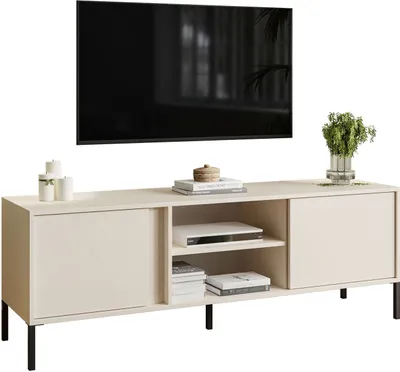 A beige TV stand with black legs, featuring sliding doors and open shelving, is shown against a white background. A television is mounted above it, and decorative items like candles and a plant are placed on top.