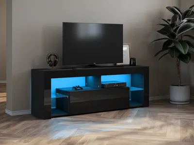 A modern black TV stand with blue LED lighting, a television, and a plant in a pot.