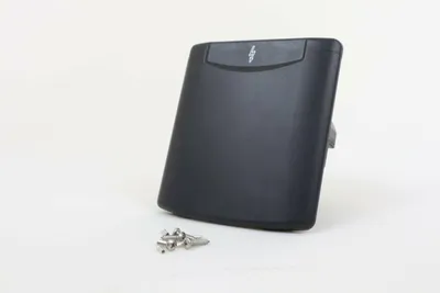 A black electrical socket with a lightning bolt symbol on a white background, with some metal screws in the foreground.