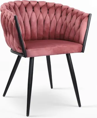 A pink velvet armchair with black legs against a white background.