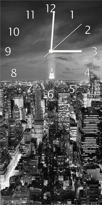 Produktbild von Wallario Design Wanduhr New York bei Nacht - Panoramablick über die Stadt - schwarzweiß aus Echtglas, Größe 30 x 60 cm