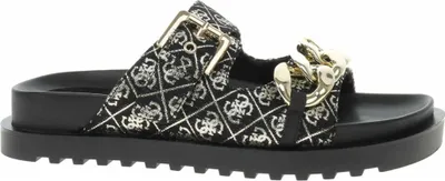 A single black Guess Fatema Pantolette sandal with gold chain detail and a patterned strap.