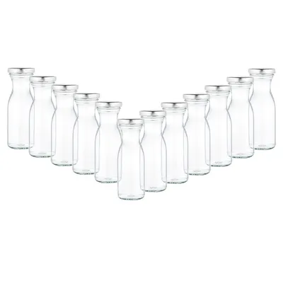 A set of clear glass milk bottles with silver twist-off lids arranged in a V-shape on a white background.