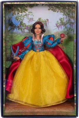 A doll of Snow White in her iconic dress, displayed in a box with a forest background.