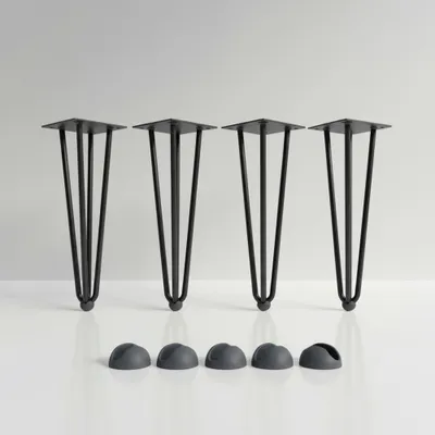 Four black hairpin legs and four black floor protectors are displayed on a white surface against a light gray background.