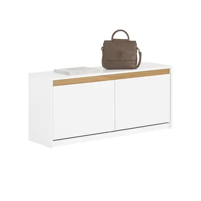 A white shoe cabinet with a wooden trim on top, a book, and a brown handbag.