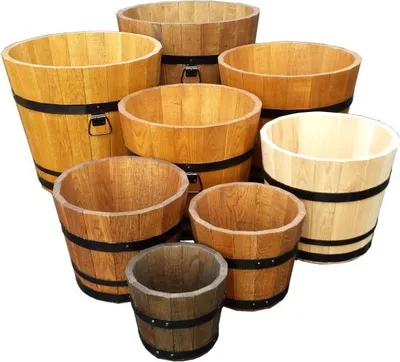 A collection of wooden planters of various sizes and shades of brown, arranged on a white background.