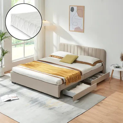 A bedroom scene featuring a beige upholstered bed with a mattress, yellow and white bedding, and a rug.