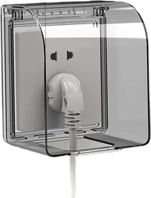 A clear, well-lit product shot of an outdoor electrical outlet cover with a plug inserted.