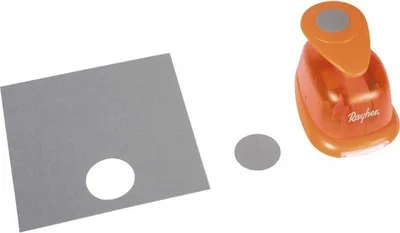 A round hole puncher with a punched-out circle and a piece of paper with a hole in it, all on a white background.