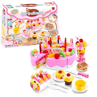 A toy birthday cake set with various accessories, displayed alongside its packaging.