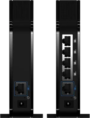 The back view of two black network devices, likely routers or bridges, are shown side-by-side against a white background. The right device displays multiple Ethernet ports and other connection interfaces.