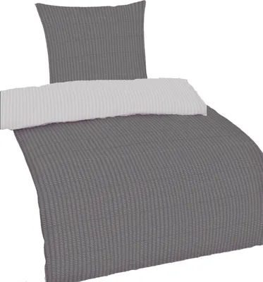 A bedding set, including a pillow and a duvet cover, laid out on a white background.