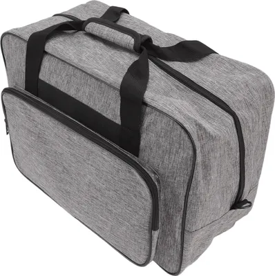 A gray sewing machine storage bag with black handles and zippers, shown from a slightly elevated side angle.