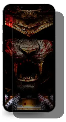 A smartphone with a screen protector featuring a dark, menacing samurai mask design.