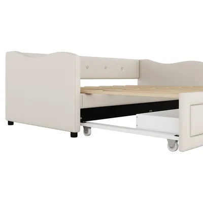 A side view of a beige daybed with a pull-out trundle bed and drawer.
