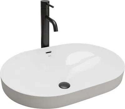 A white oval basin with a black faucet.