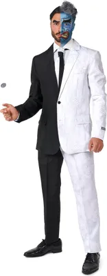 A man dressed in a two-tone suit, half black and half white, with corresponding face paint, is shown against a white background. He is tossing a coin.