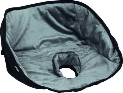 A close-up view of a black and gray pet potty pad with a hole in the center.