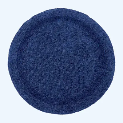 A round, dark blue bath mat with a textured surface and a raised border.