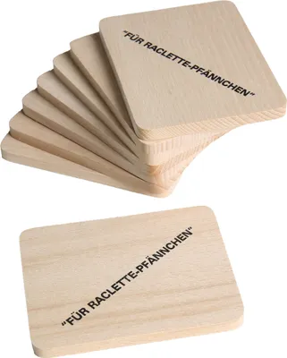 A stack of wooden coasters with text printed on them, and one coaster laid out separately.