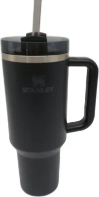 A black Stanley tumbler with a straw and handle.