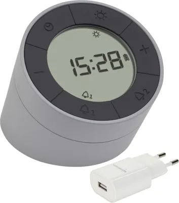 A digital alarm clock and a USB power adapter.