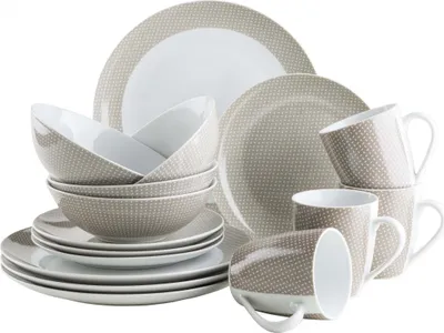 A collection of porcelain dinnerware, including plates, bowls, and mugs, arranged on a white background.