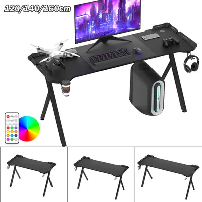 A gaming desk setup with a computer, monitor, keyboard, mouse, headphones, and a drone.
