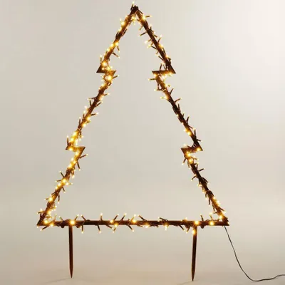 A decorative Christmas tree outline illuminated with warm white LED lights, standing on two stakes.