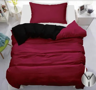 A bed with burgundy and black bedding.