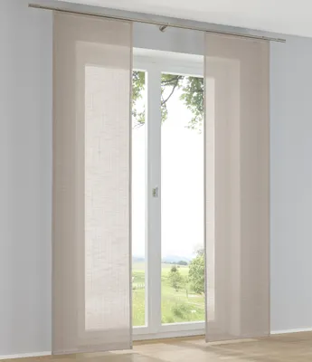 Panel curtains hanging in front of a window with a view of a green landscape.