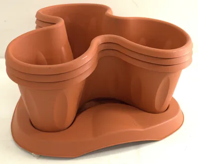 A terracotta-colored modular planter set with a base tray.