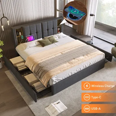 A bedroom scene featuring a bed with storage drawers, a tablet, and a wireless charging pad.