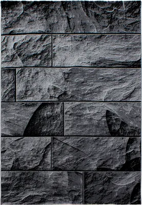 A close-up, full-frame shot of a textured, dark gray stone wall pattern.