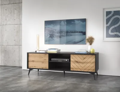 A modern living room with a TV stand and television.