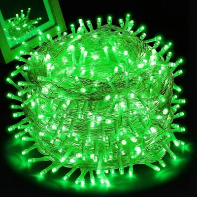 A coiled bundle of green LED string lights against a black background.