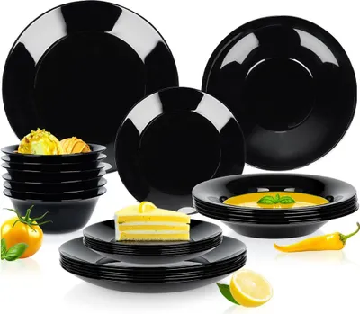 A collection of black dinnerware, including plates, bowls, and a slice of cake, arranged on a white background.
