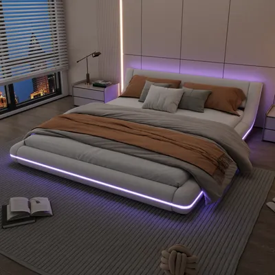 A modern bedroom with a white LED bed, nightstands, and a window overlooking a city at night.