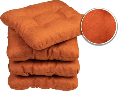 A stack of four orange seat cushions.