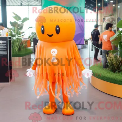 Productafbeelding van Mascot REDBROKOLY karakter van een oranje kwal gekleed met een capribroek en reversspeldjes
