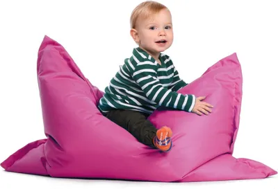 A baby sitting on a pink beanbag chair.