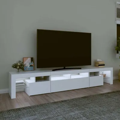 A modern white TV stand with LED lighting, featuring a large flat-screen television on top.