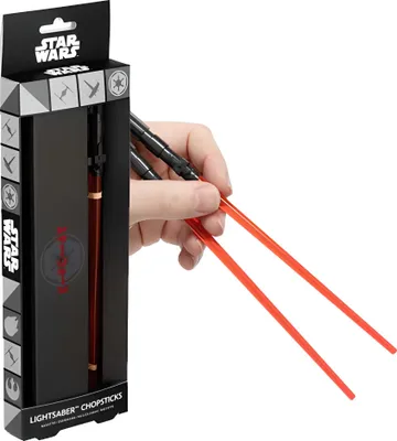 A hand holding Star Wars lightsaber chopsticks, with the product packaging visible on the left.