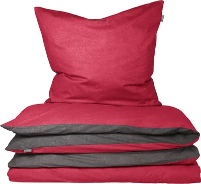 A stack of folded bedding, including a pillow and duvet cover, in red and dark gray.