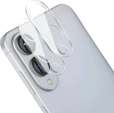 A close-up view of camera lens protectors placed on top of a smartphone's camera module.