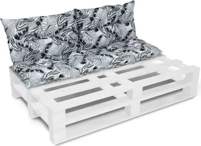A white pallet sofa with black and white patterned cushions.