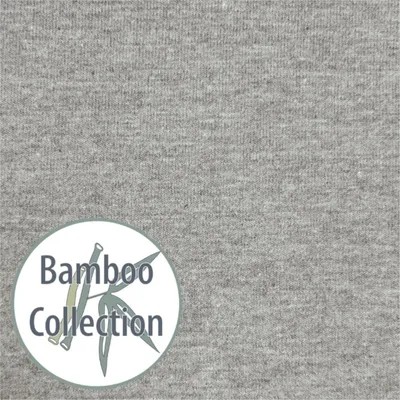 A close-up of grey fabric with a circular logo containing text and a bamboo illustration.