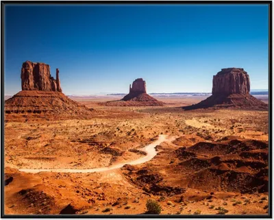 Produktbild von Wallario Wandbild Monument Valley unter blauem Himmel, Größe: 40,30 x 50,30 cm, Poster mit schwarzem Aluminiumrahmen