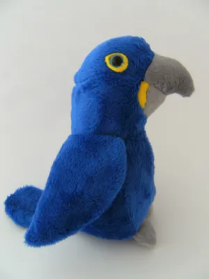 A plush toy of a hyacinth macaw is shown against a plain white background.
